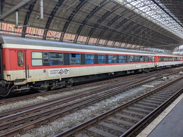 Red and white carriage with Euroepan Sleeper logo at platform