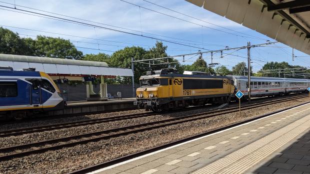 Photo of NS 1700 locomotive, number 1761, pulling DB coaches at Hilversum station.