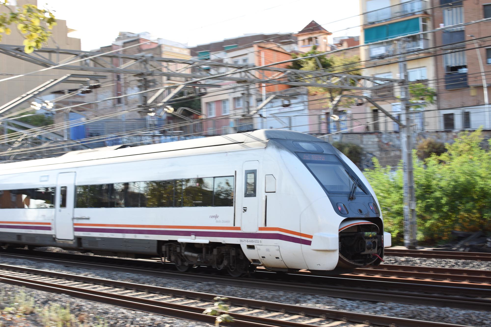 Serie 449 train speeding along the tracks outside Santa Eulalia.