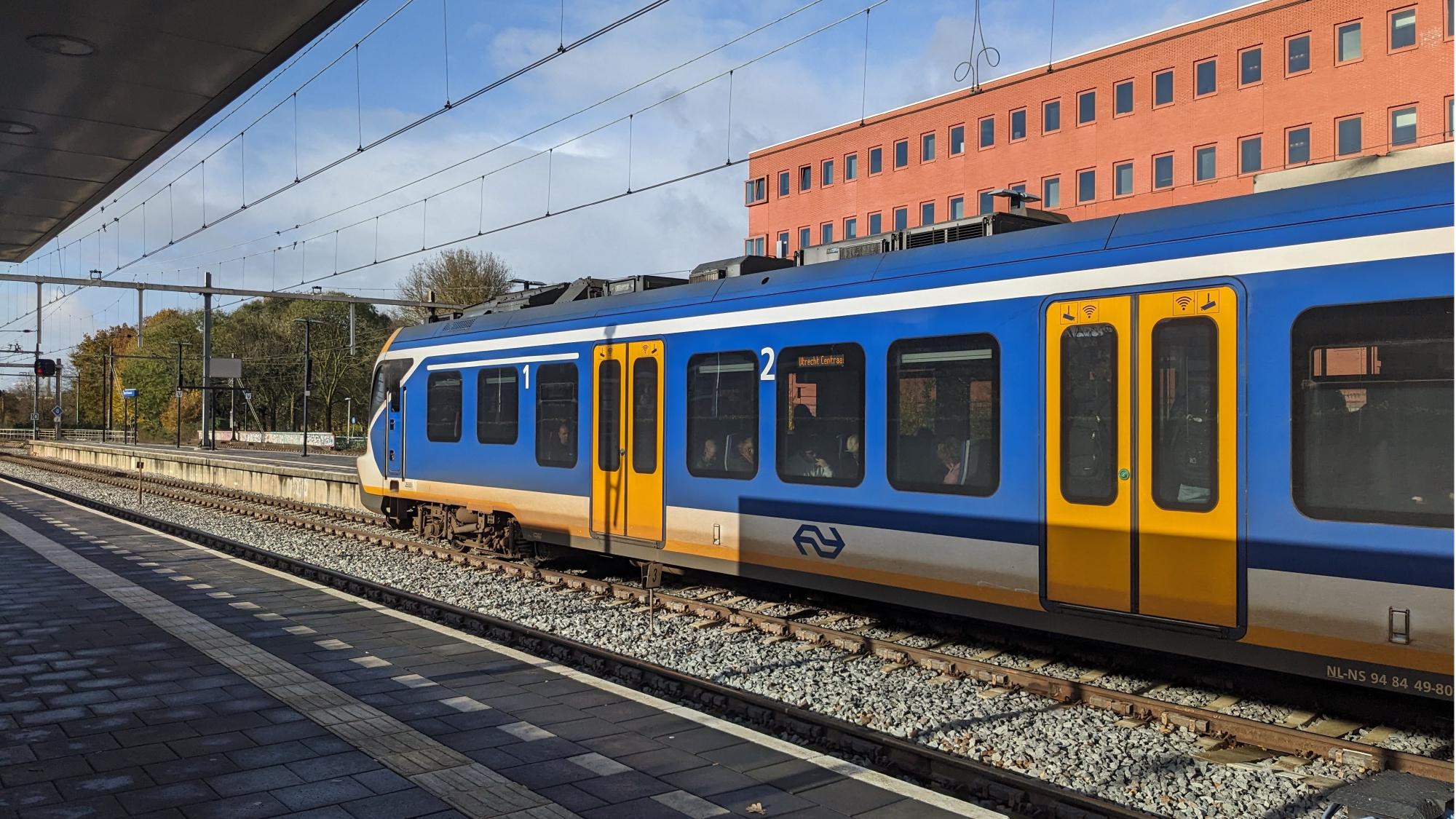 Side of SNG train waiting at the platform with passengers inside.