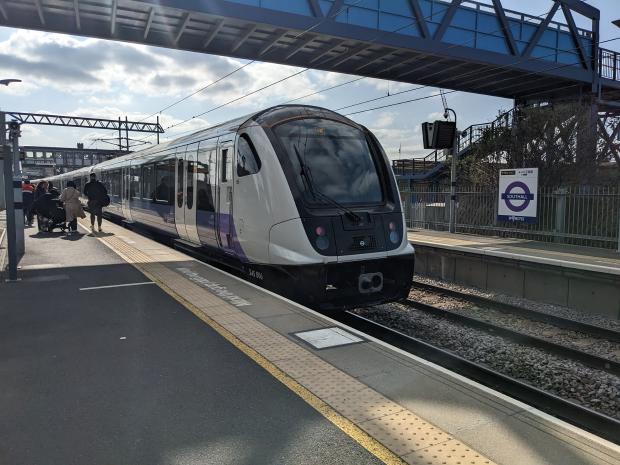 Picture of Class 345 EMU, number 006, on platform at Southall station under a pedestration bridge with passengers disembarking.